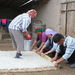 At-Bashy, Naryn Region Rolling up the wool in rush mat while soaking it with hot water which holds a little soap